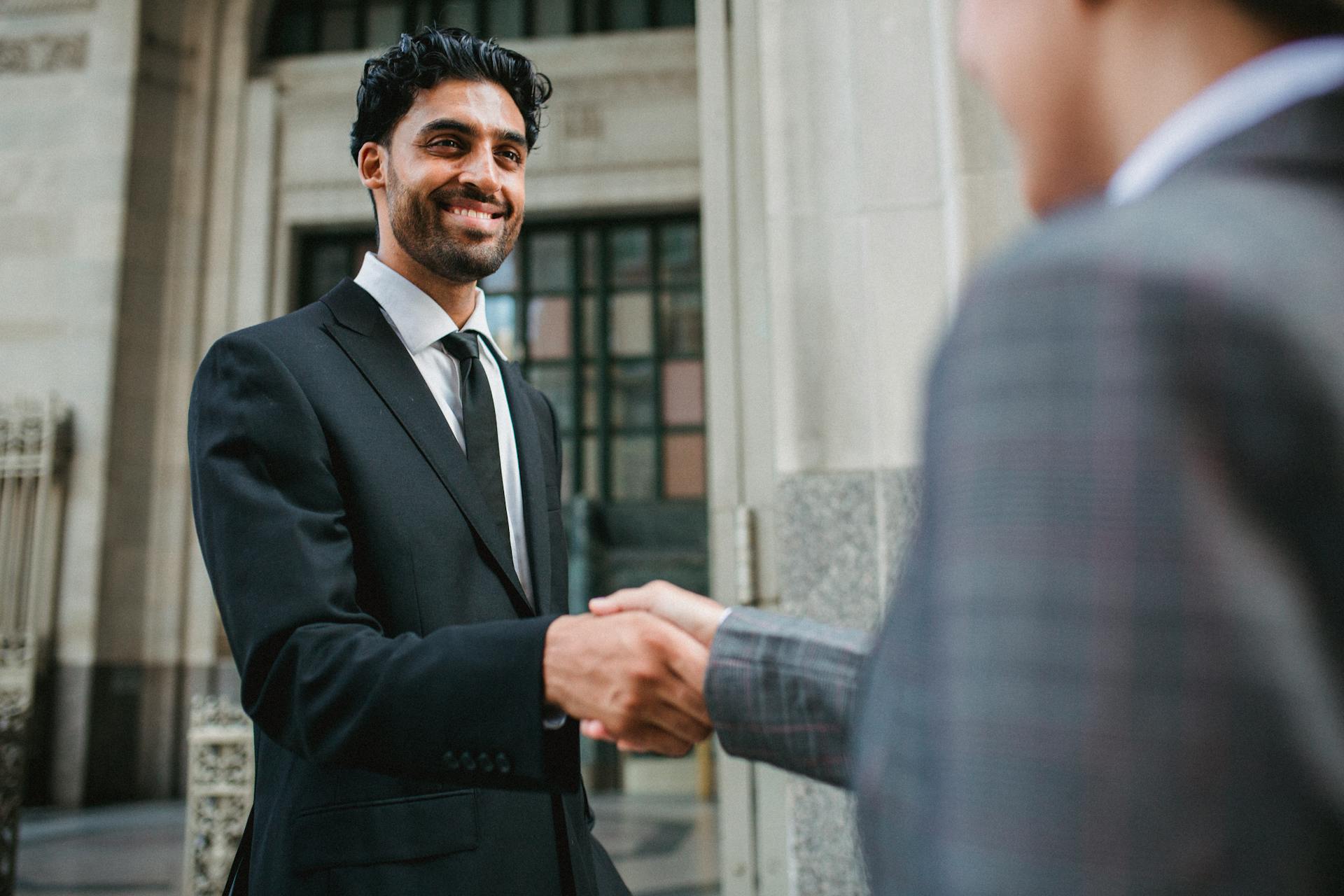 A businessman shaking hands with a colleague.