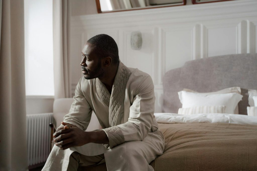 A man sitting on the bed.