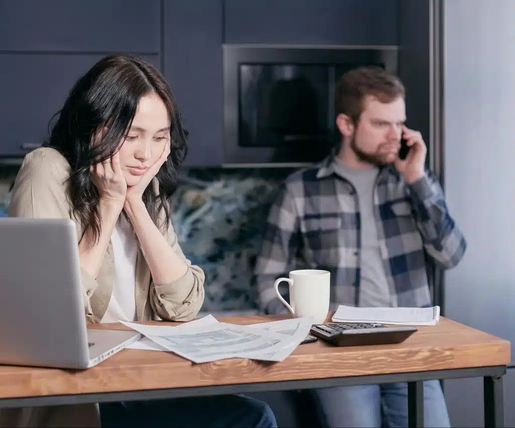 A man busy and a woman waiting for him