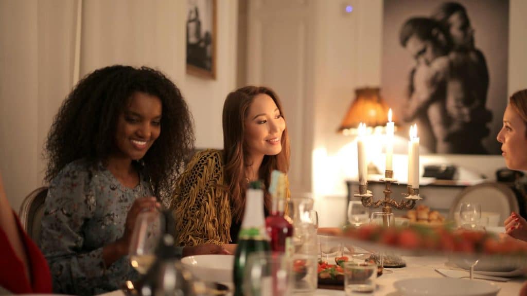 Women talking while having dinner.