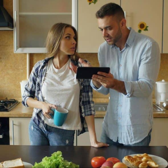 A man showing something to woman