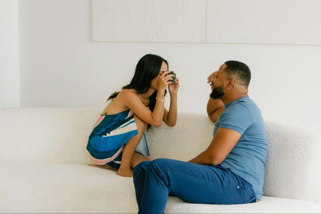 A woman taking a picture of a man