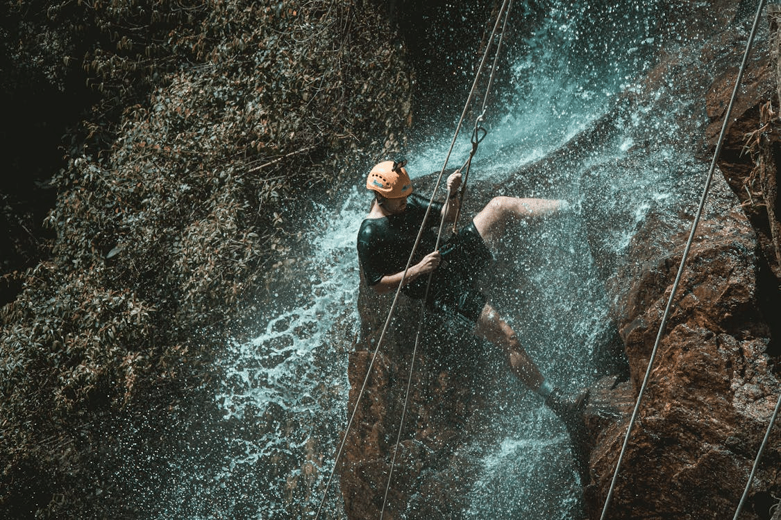 A man rappelling on cliff