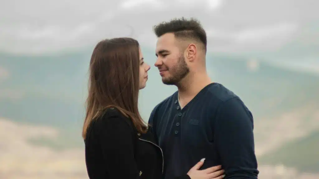 A couple smiling at each other.