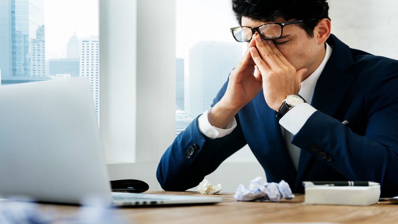 A man looking frustrated at work