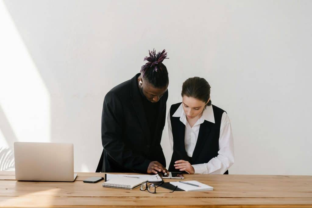 A man looking at the woman’s work