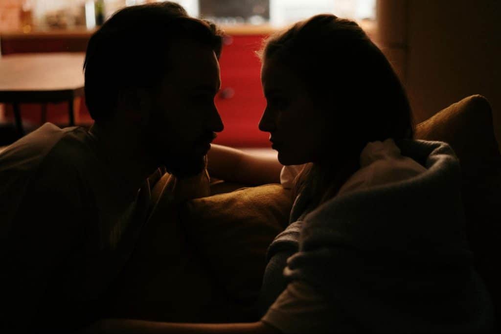 A silhouette of a couple looking at each other