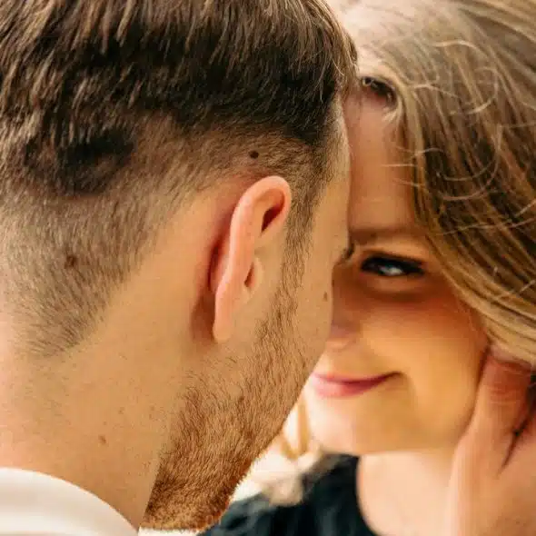 A close-up of a couple sharing an intimate moment.