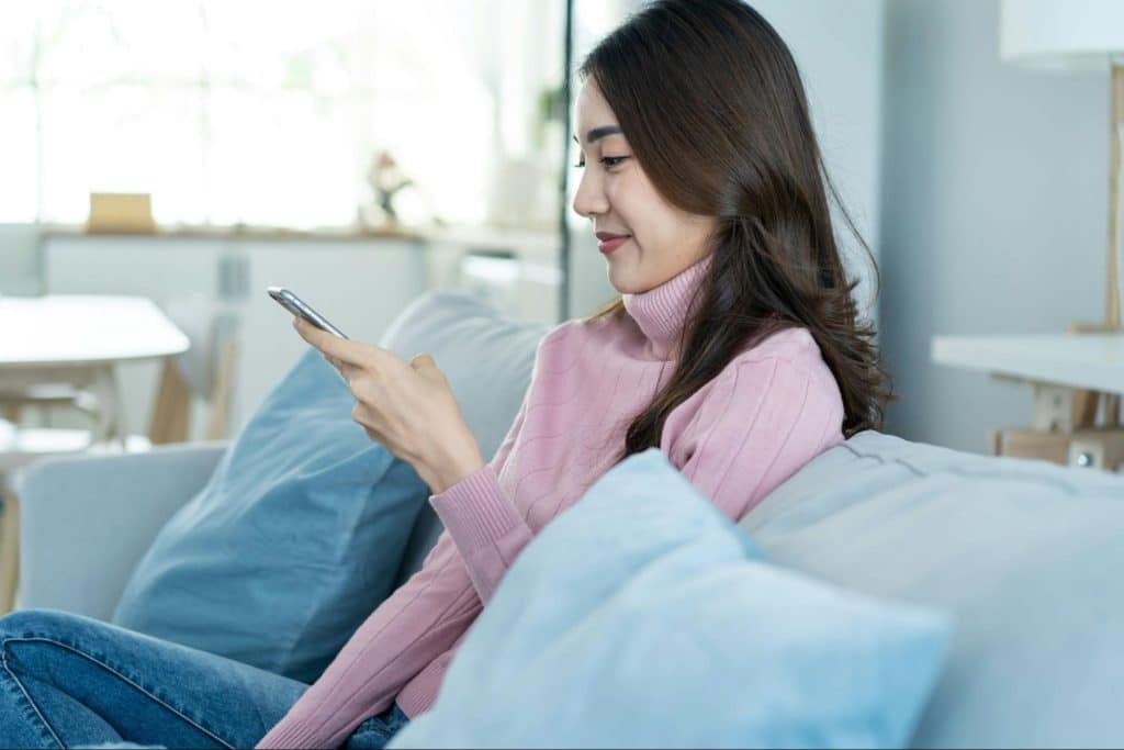 A woman using a phone but not to contact her partner