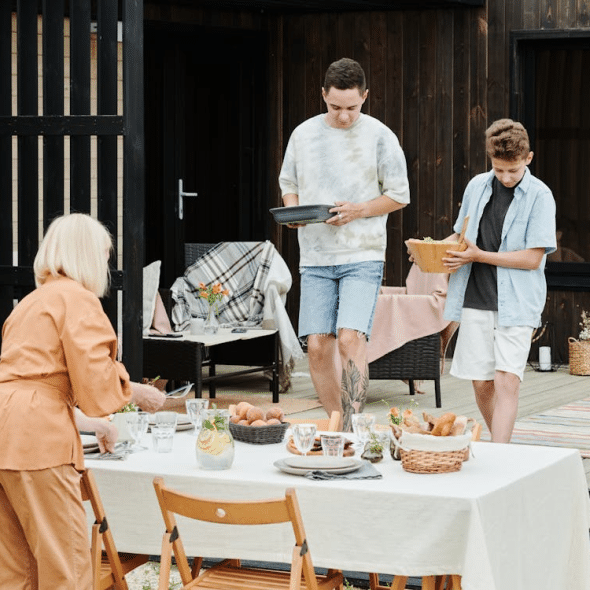 Mother and sons preparing table