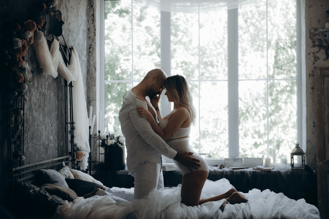 Man and woman kneeling on the bed