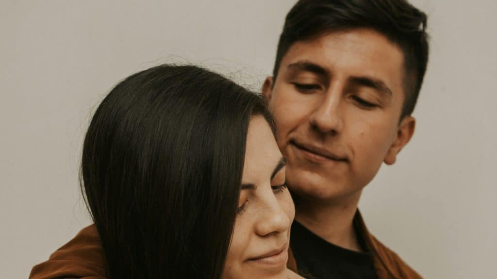 A man and a woman embracing each other.