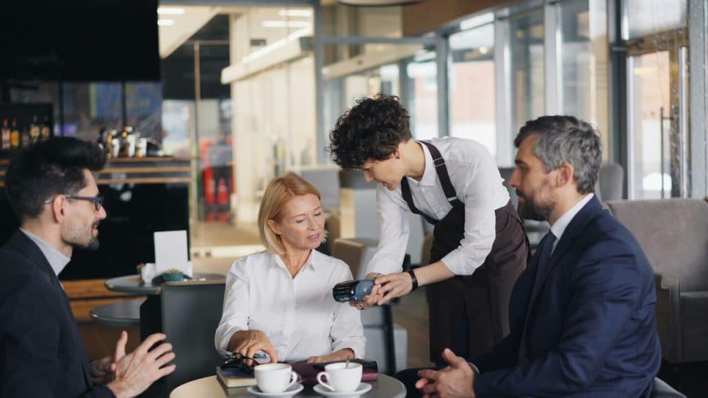 Colleagues talking to a waiter