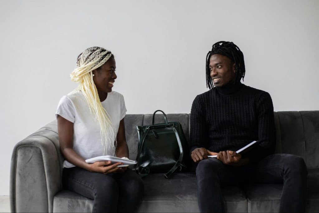 A man and woman sitting at the couch