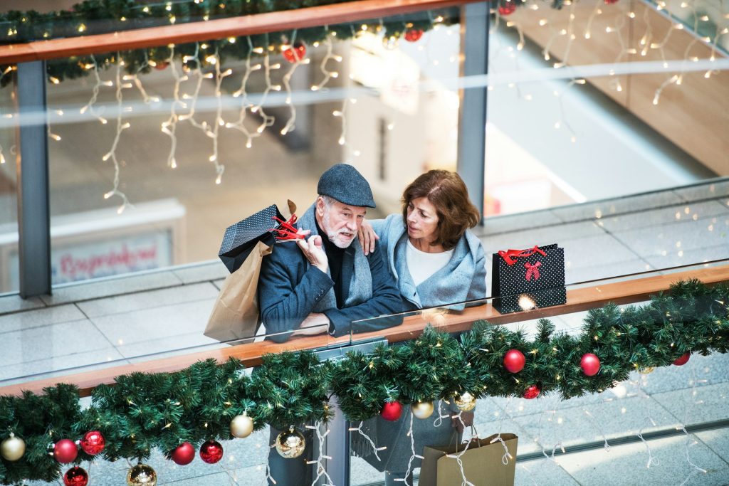 A senior couple shopping during the holidays.