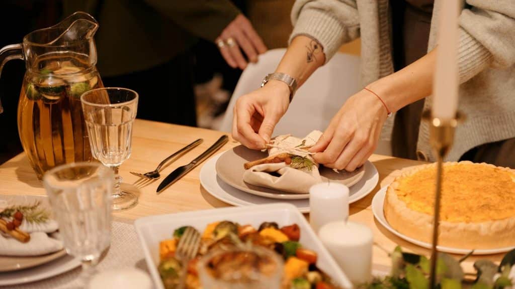 A woman setting the table.