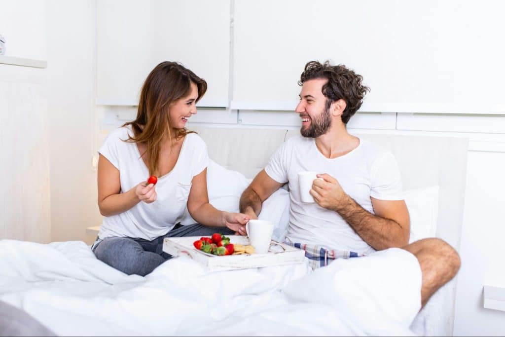 A man and woman at the bed