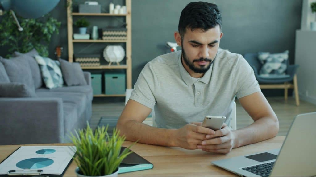 A man alone and using his phone
