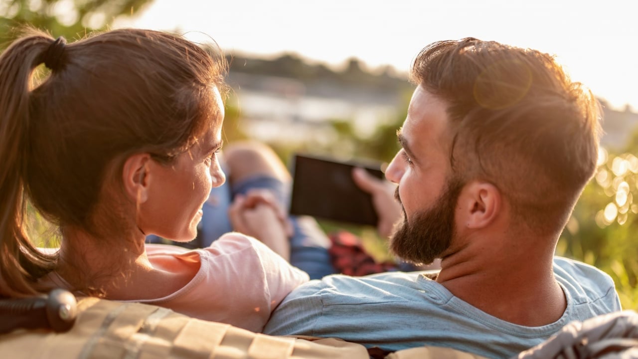 A couple taking a selfie while sitting together.