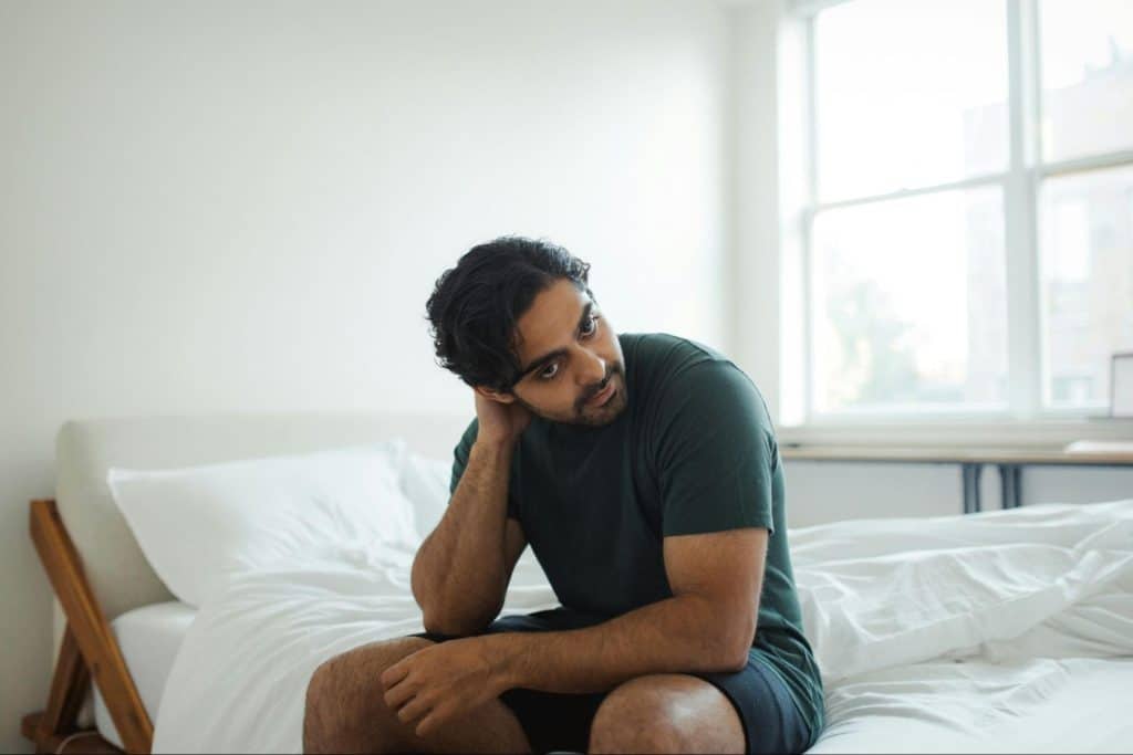 A man sitting at the bed