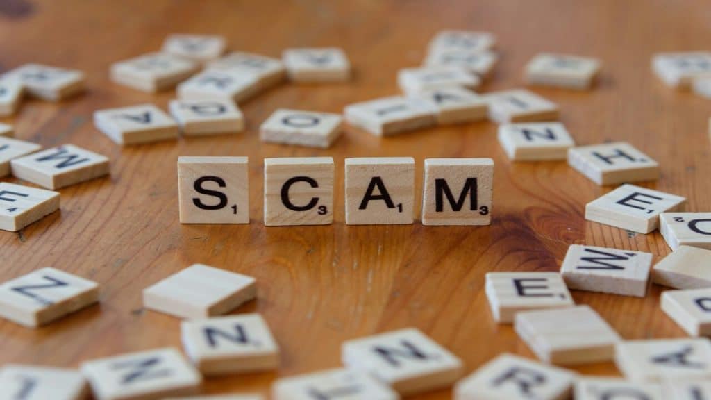 Scrabble letters spelling out “scam”