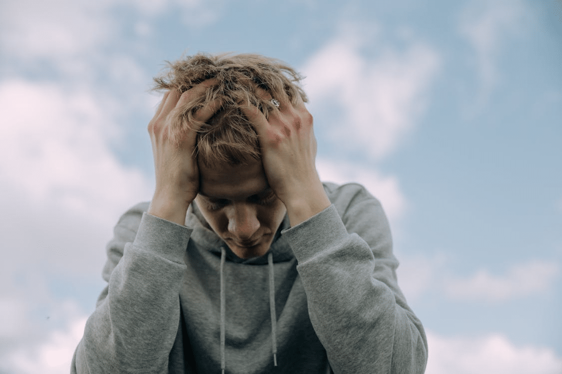 A man holding his head