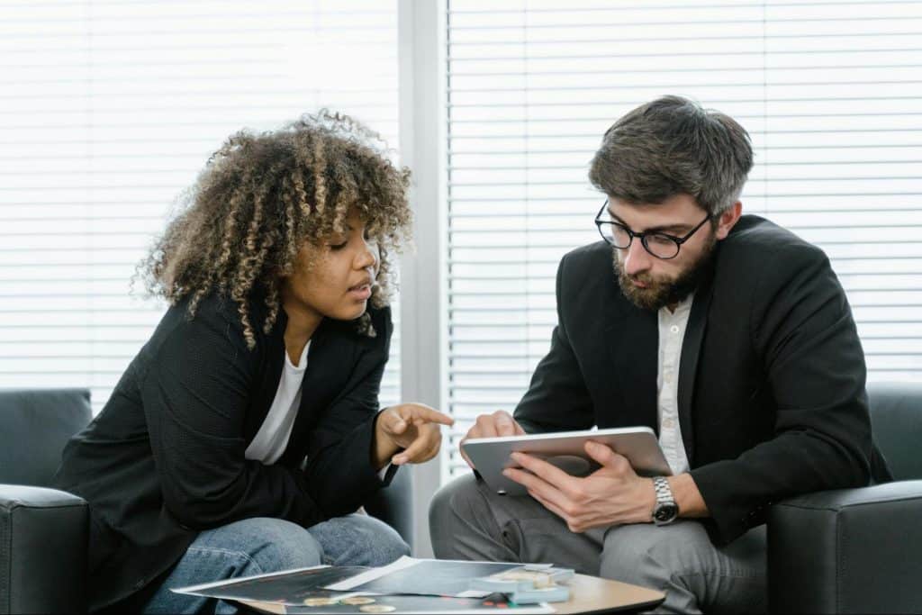 A man teaching something to woman