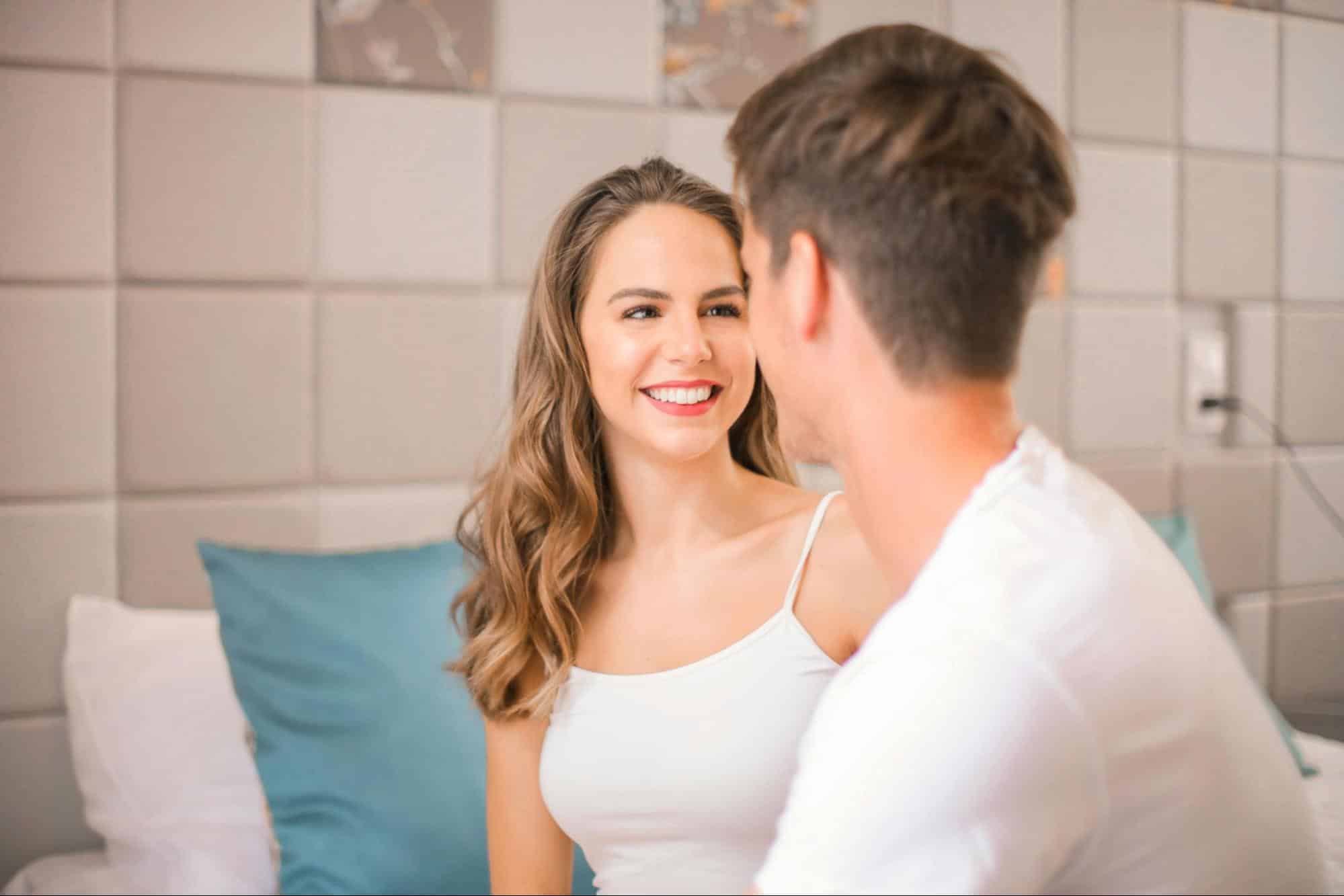 A woman looking at the man