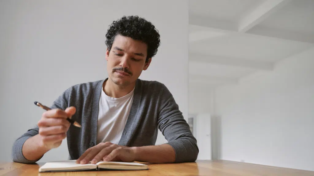 A man writing on his journal