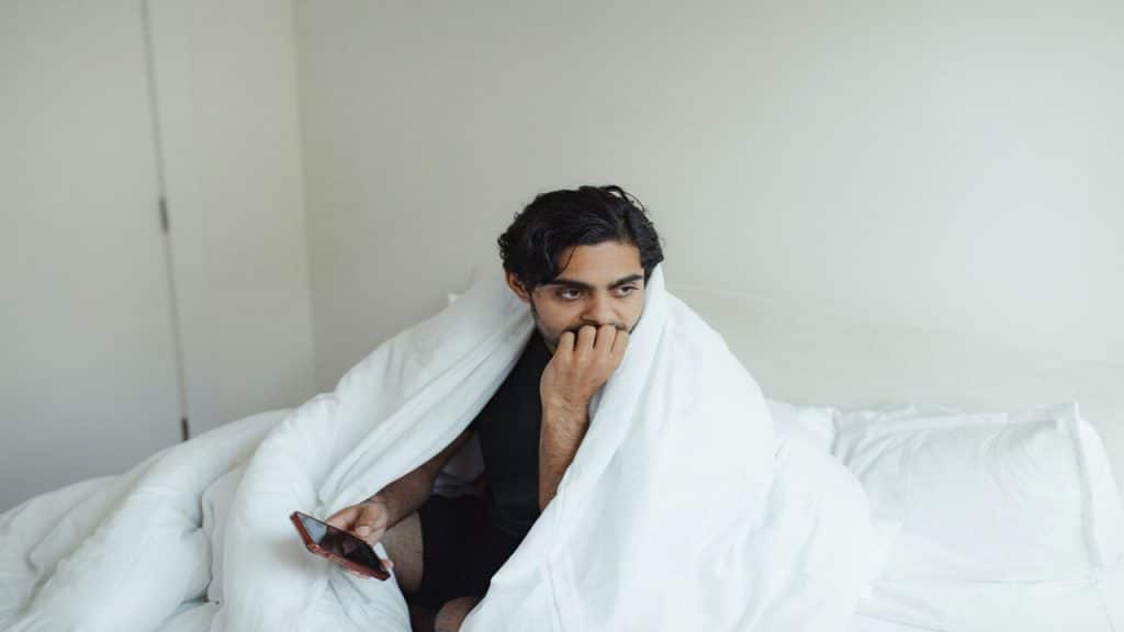 A man looking sad in the bedroom