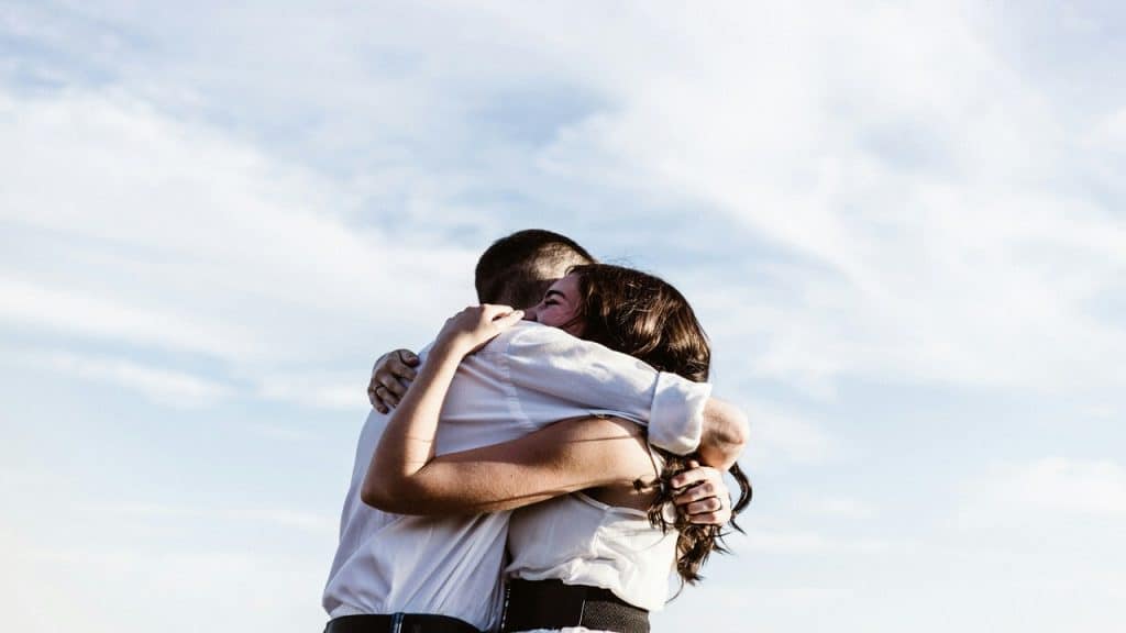 A couple hugging outdoors