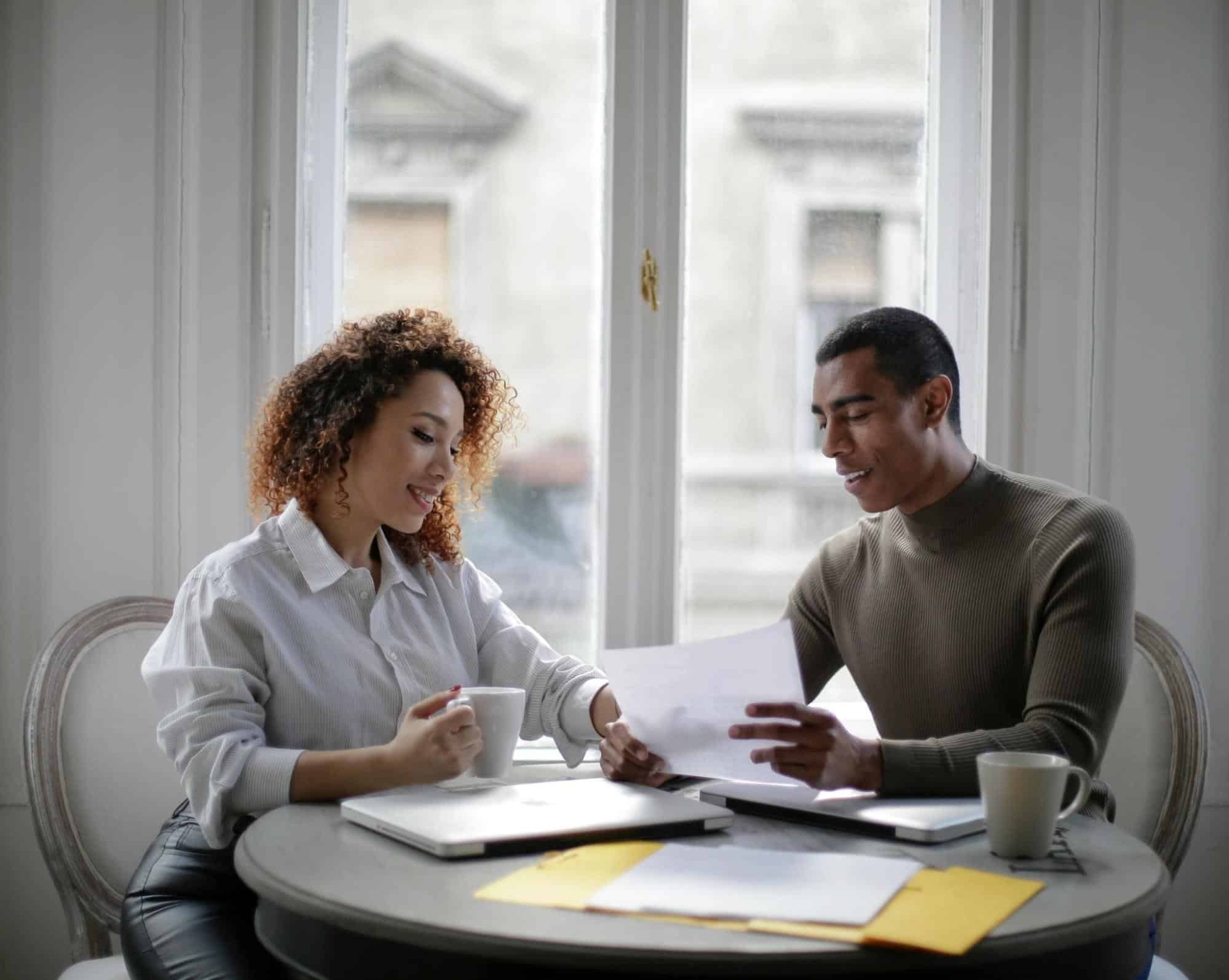 A man and woman looking at the documents