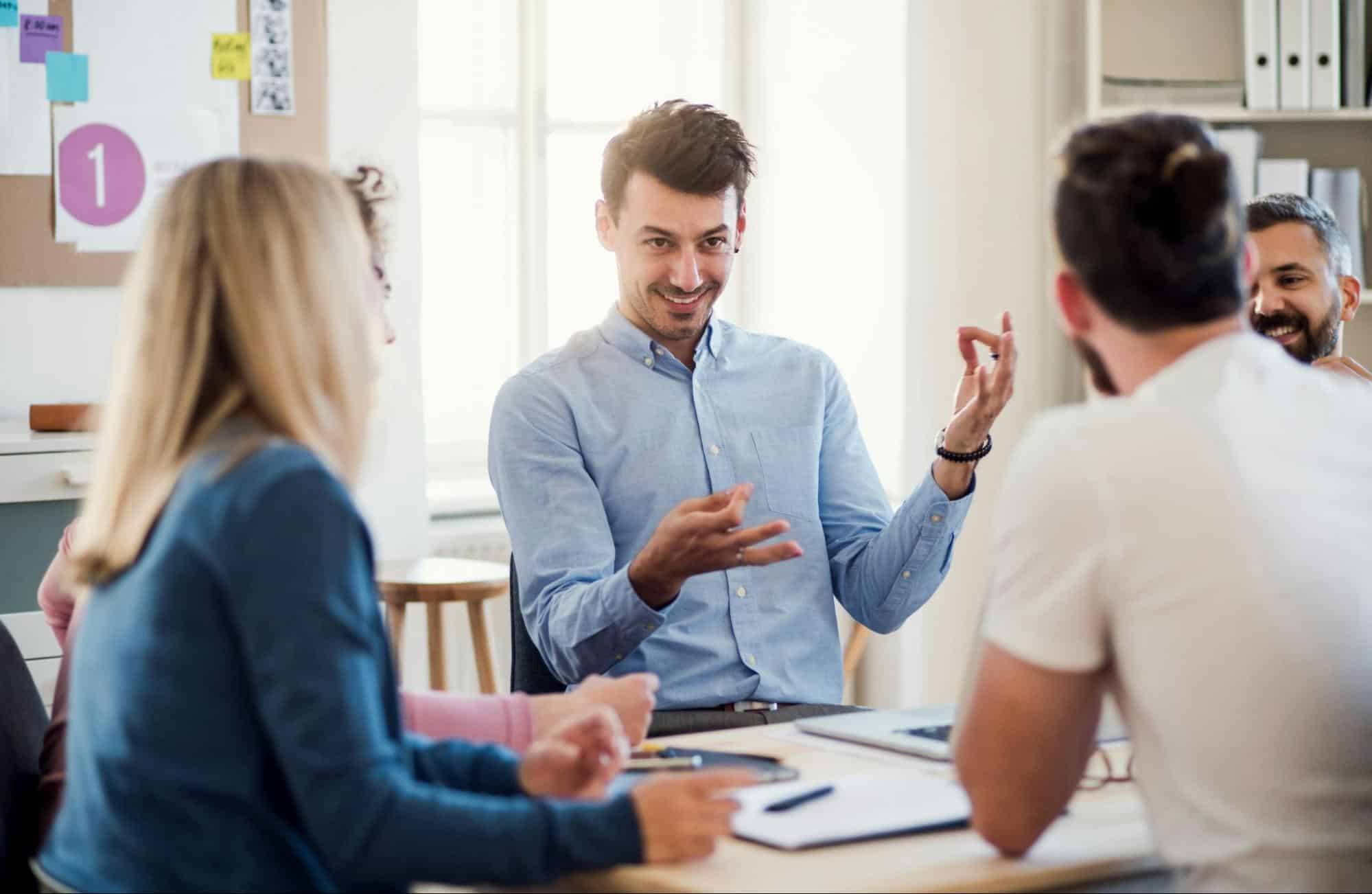 A man talking to his colleagues
