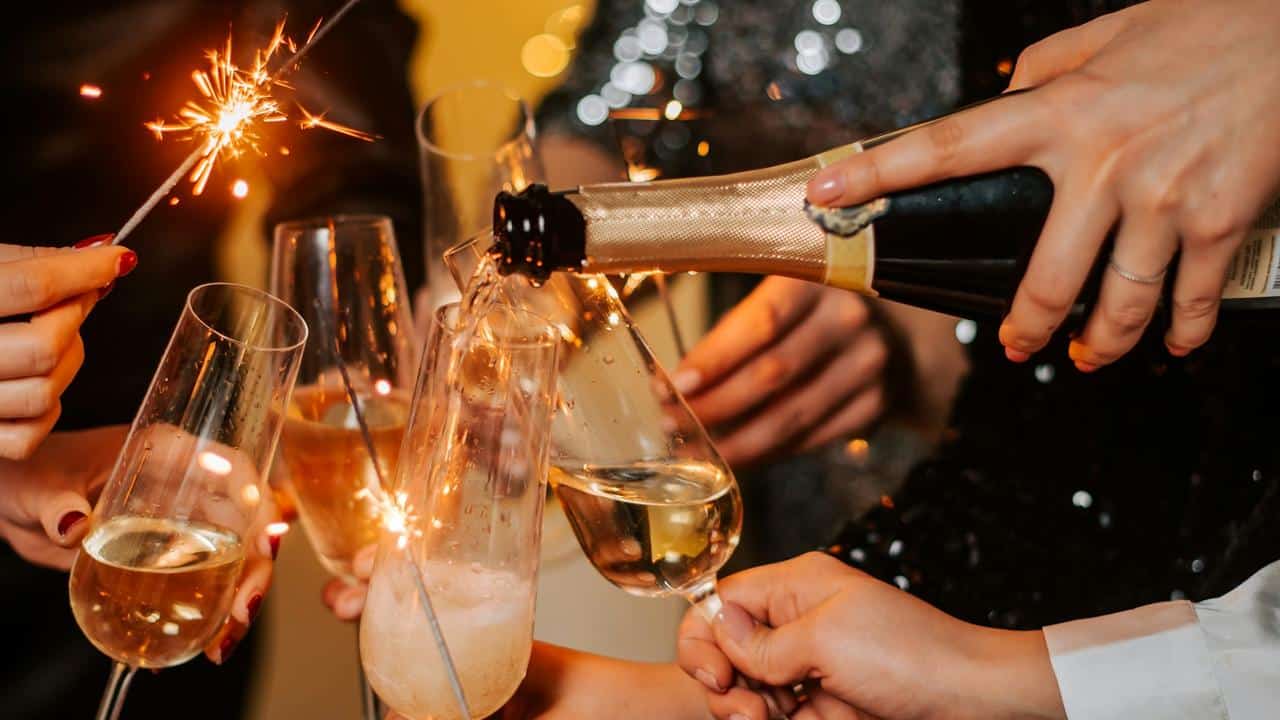 A group celebrating with champagne and sparklers.