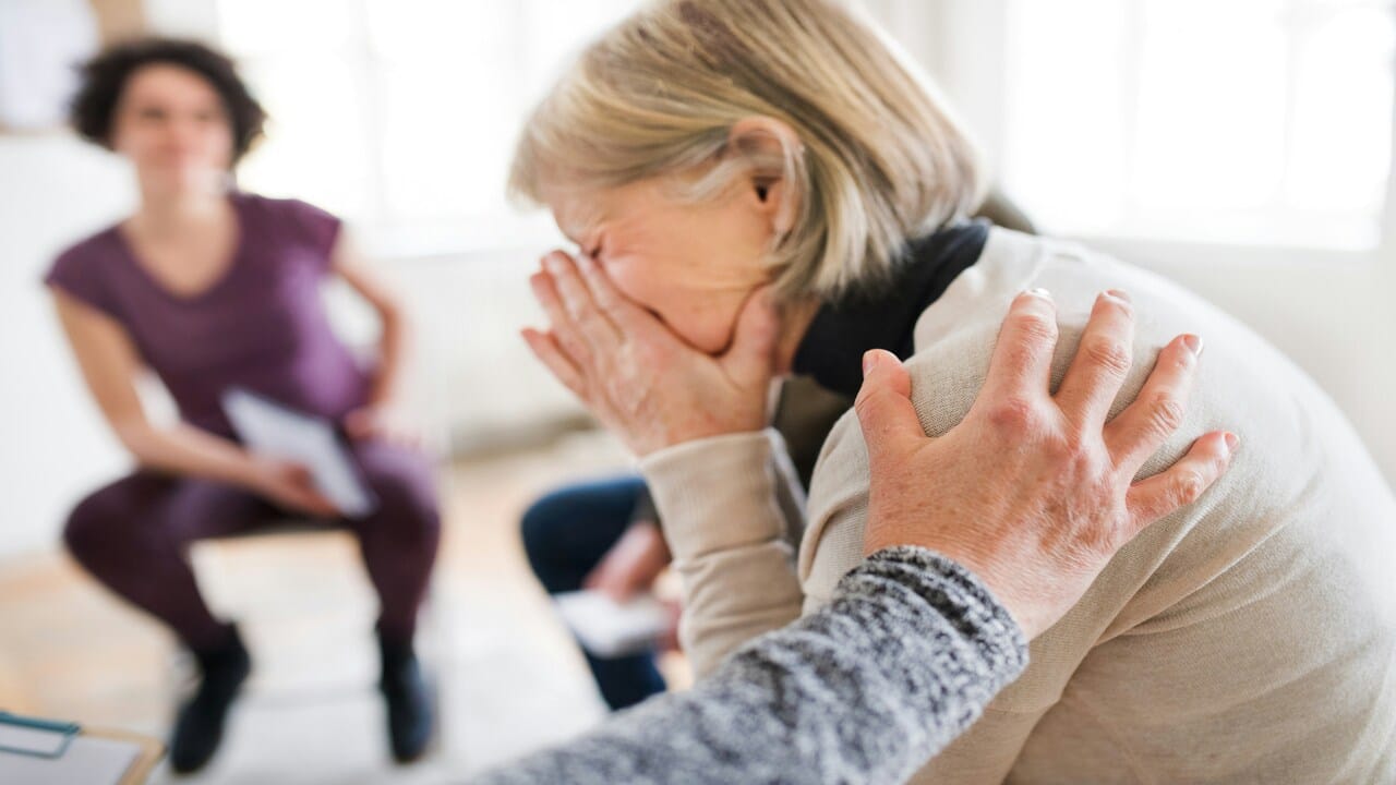 A woman crying during group therapy