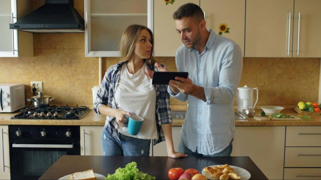 A man and woman at the kitchen