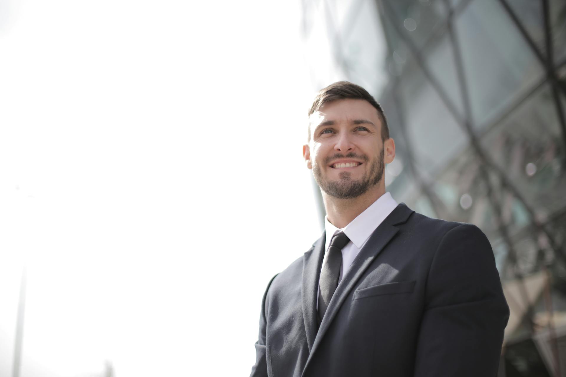 A man in black suit smiling.