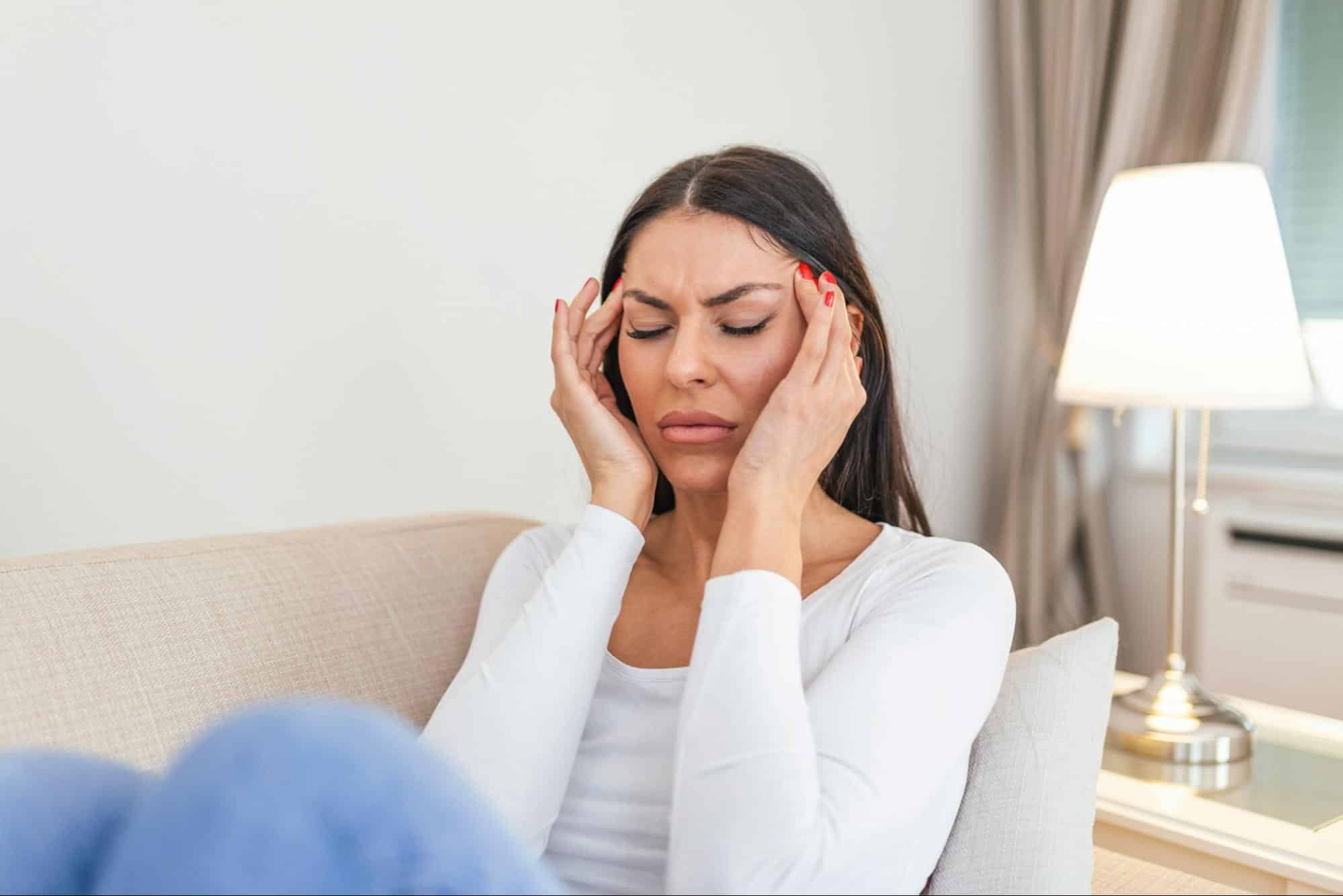 A woman holding her head 