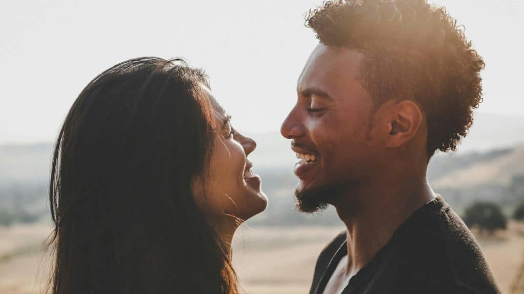 A couple smiling at each other.