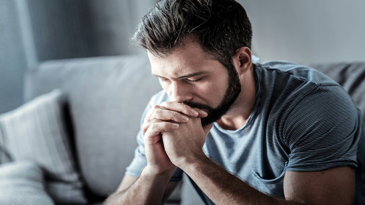 A man looking upset at home