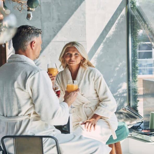 A mature couple talking over mimosas
