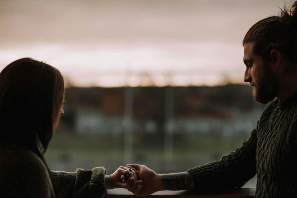 A man holding a woman’s hand