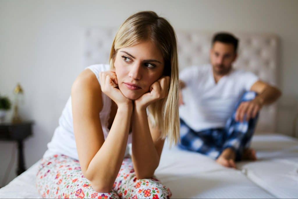 A sad woman and a man behind her