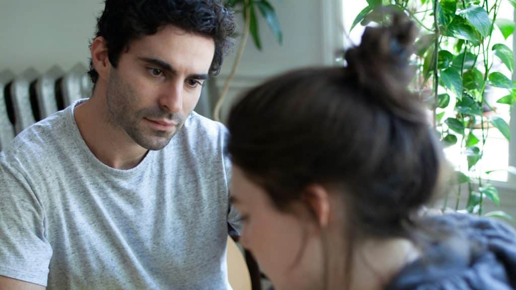 A man staring at a woman with an intense expression.