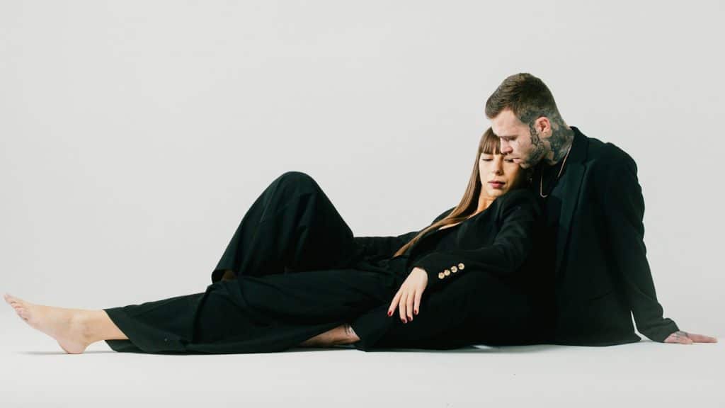 A man and a woman sitting on the floor.