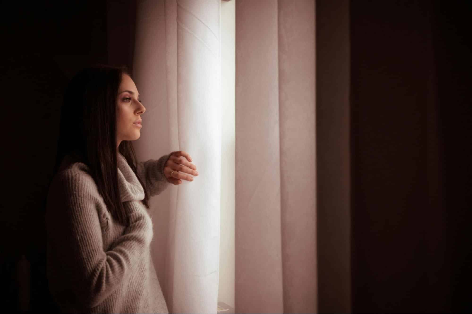 A woman looking at the window
