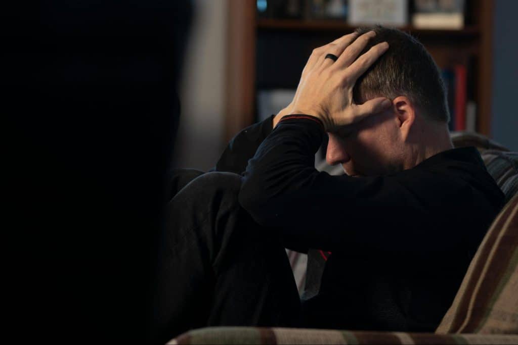 A man holding his head