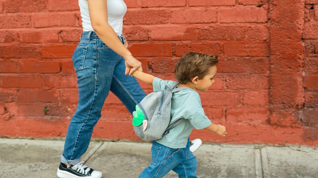 A woman taking her kid to school