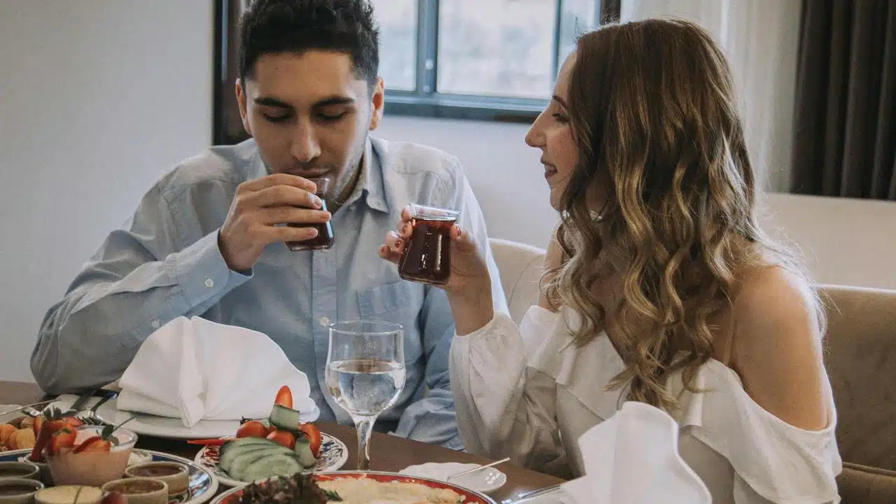 A couple enjoying tea together at a restaurant table.