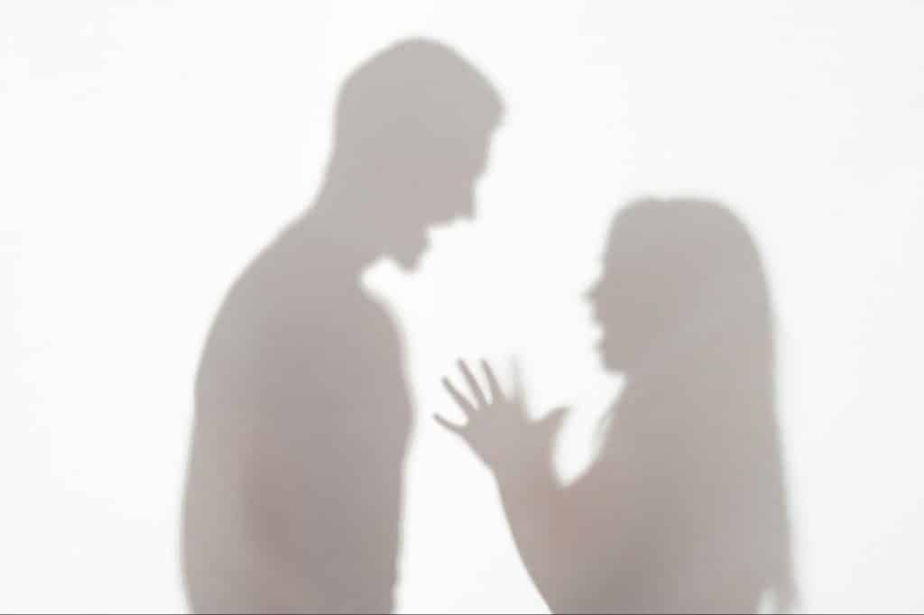 A shadow of a man and woman shouting at each other